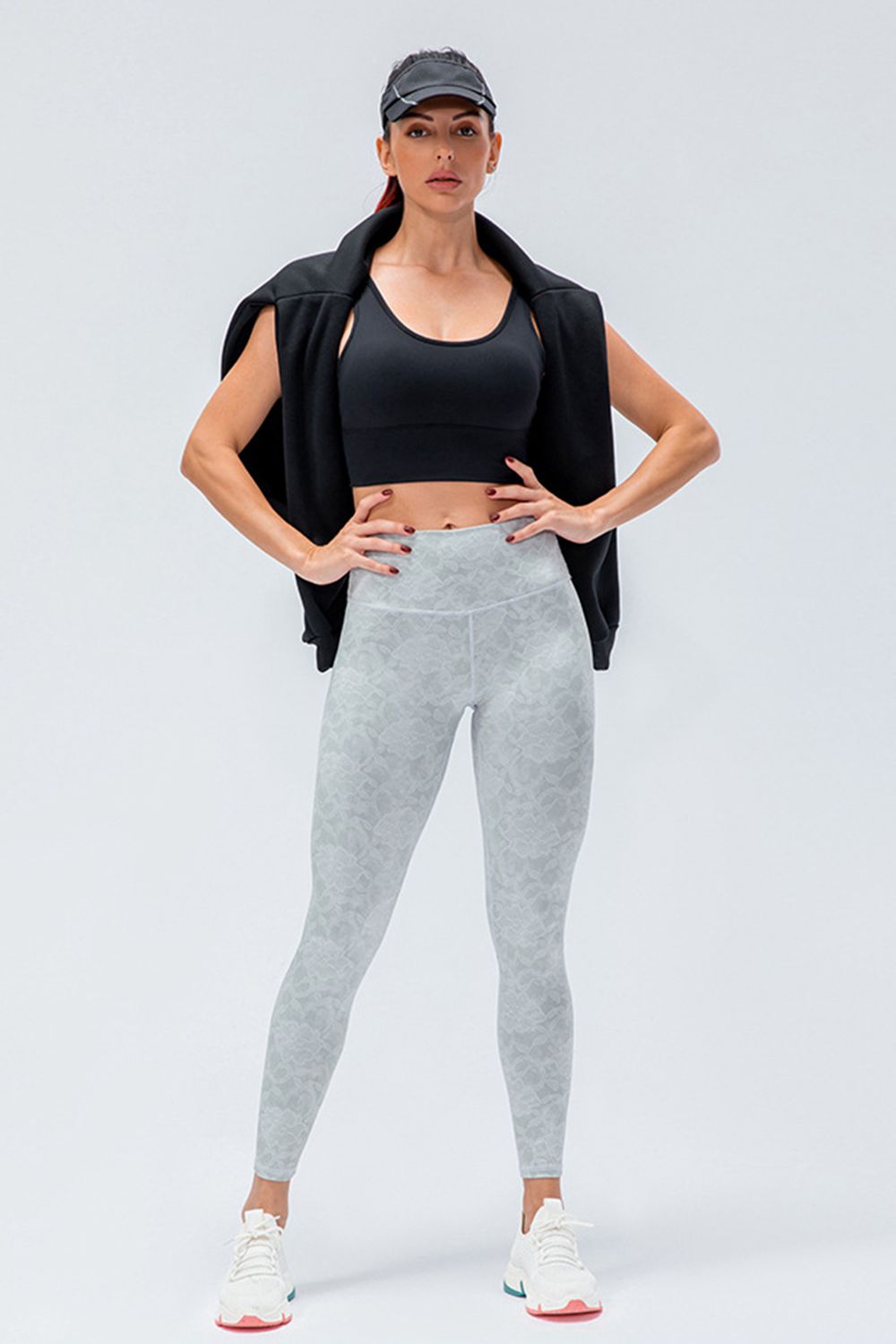 Gray patterned high-rise performance leggings with a white waistband.