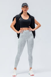 Gray patterned high-rise performance leggings with a white waistband.