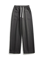Dark gray casual loose fit sweatpants with white drawstring and pockets.