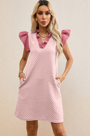Blush pink trapeze dress with textured fabric, ruffle sleeves, and pockets.