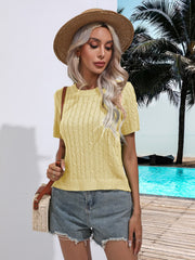 Light yellow cable knit crew neck sweater with short sleeves and textured knit detail.