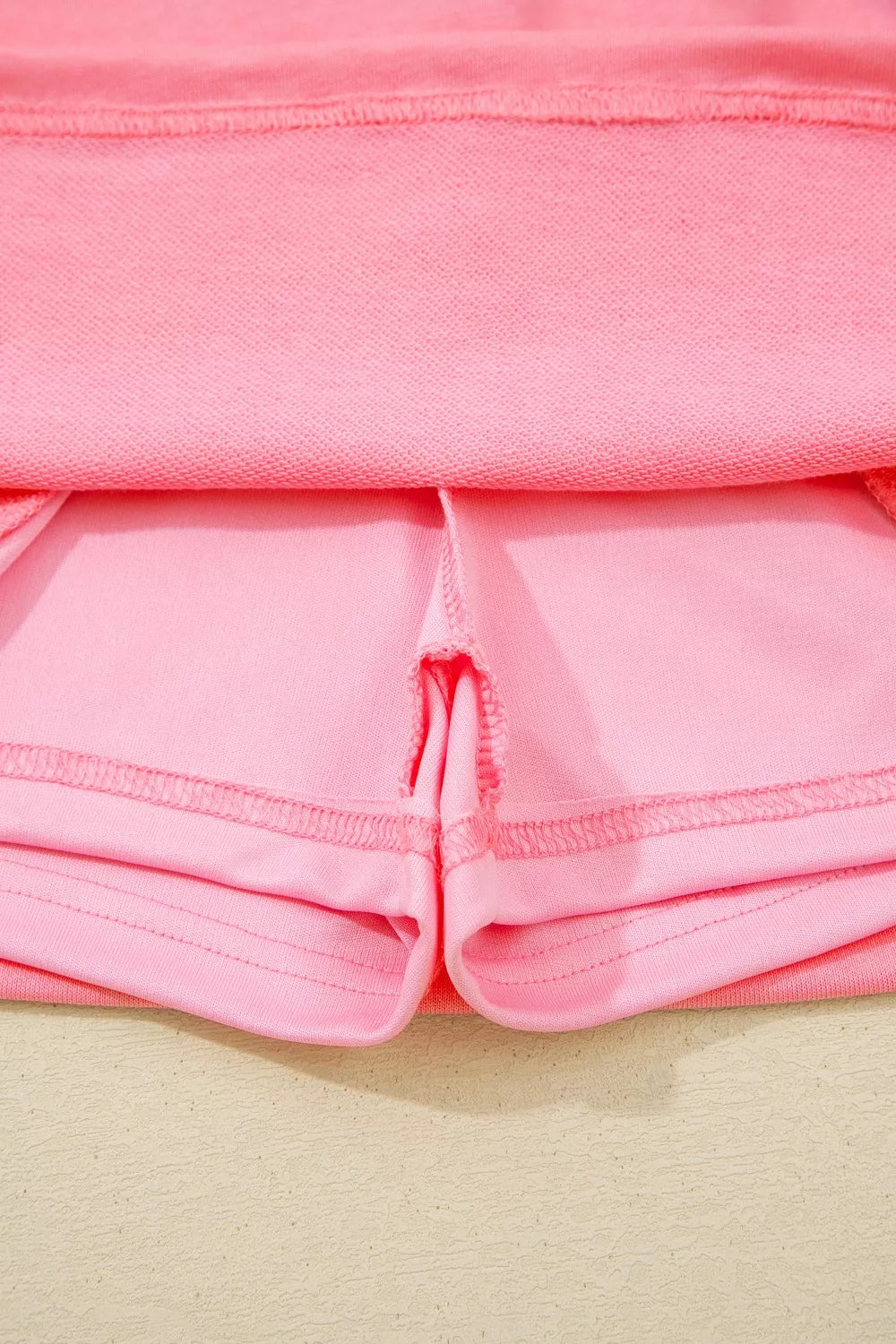 Dusty pink skort with visible stitching details and pocket lining.
