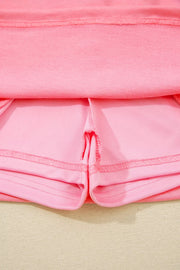 Dusty pink skort with visible stitching details and pocket lining.