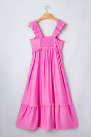 Pink ruffled sleeveless maxi dress with smocked waist and tiered skirt.