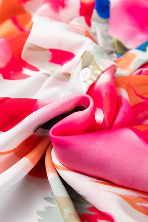 Painterly abstract print blouse with ruffle front detail in pink.
