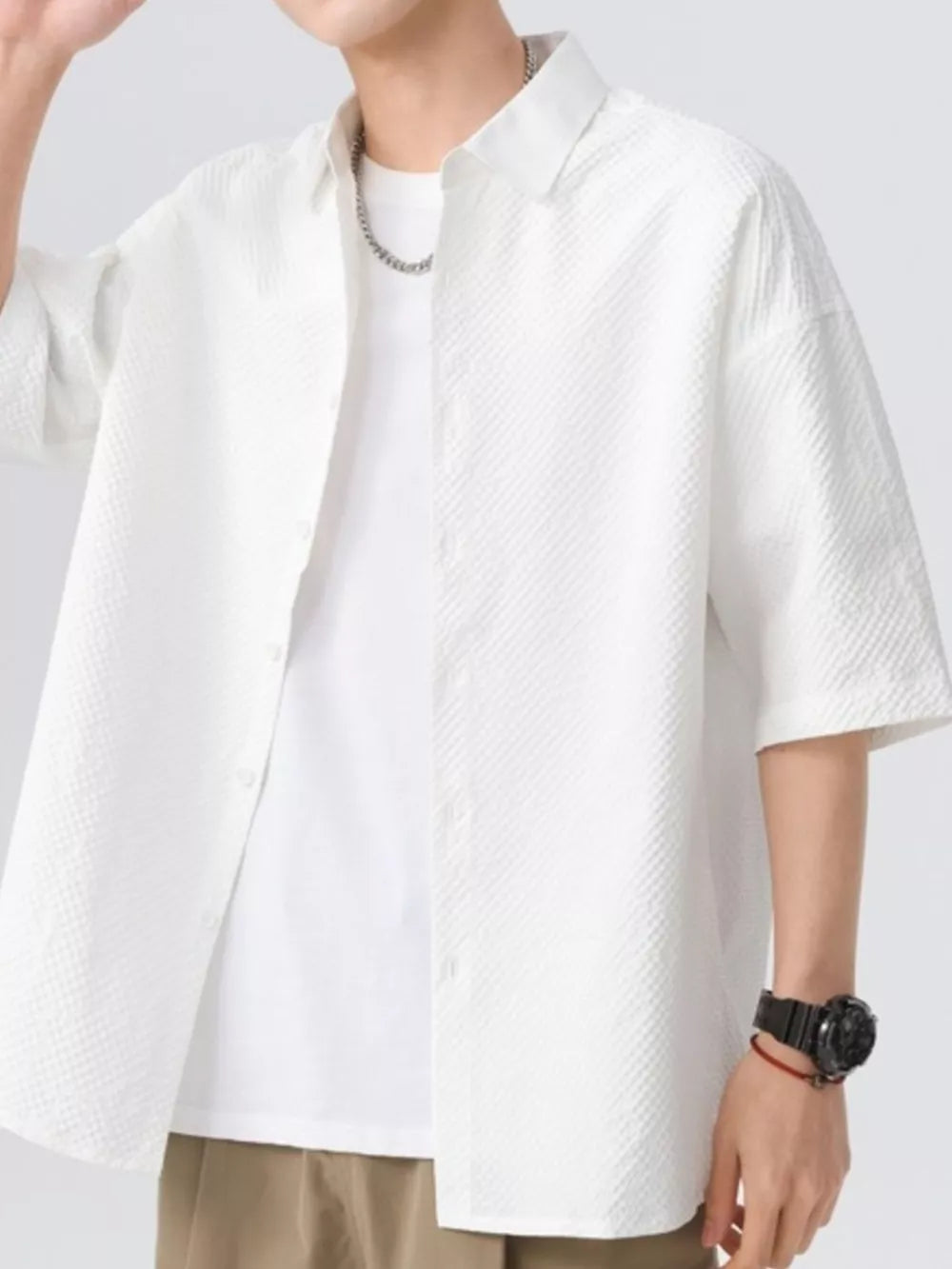 White textured short-sleeve men's shirt with button-up front and collar.
