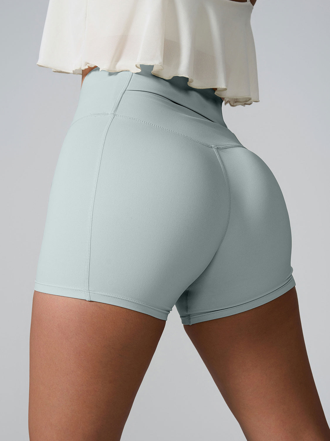Light Green active shorts with sculpted pocket detail and seamless back.