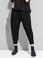 Black pinstripe harem maternity pants with pockets and elastic waist.