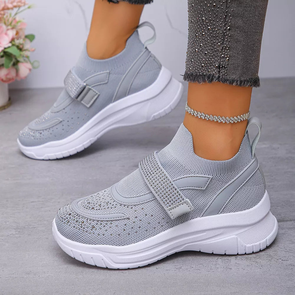 Gray slip-on mesh sneakers with adjustable strap and rhinestone details.