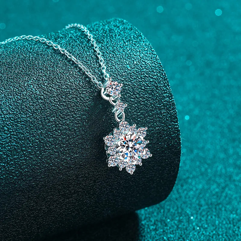 Silver moissanite pendant necklace with a floral snowflake design.