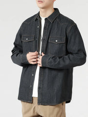 Black relaxed fit denim shirt with buttoned pockets and collar.