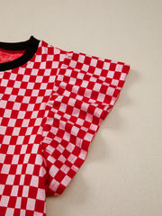Red and white checkered shirt with ruffle sleeves and black trim neckline.