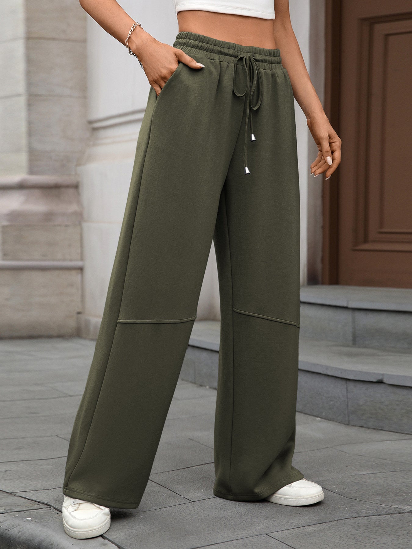 Army green high-waist drawstring wide-leg pants with pockets and a relaxed fit.