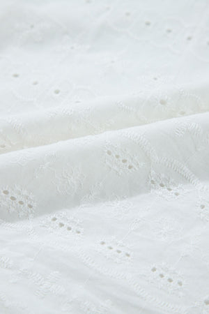White eyelet blouse with floral embroidery and ruffle sleeve detail