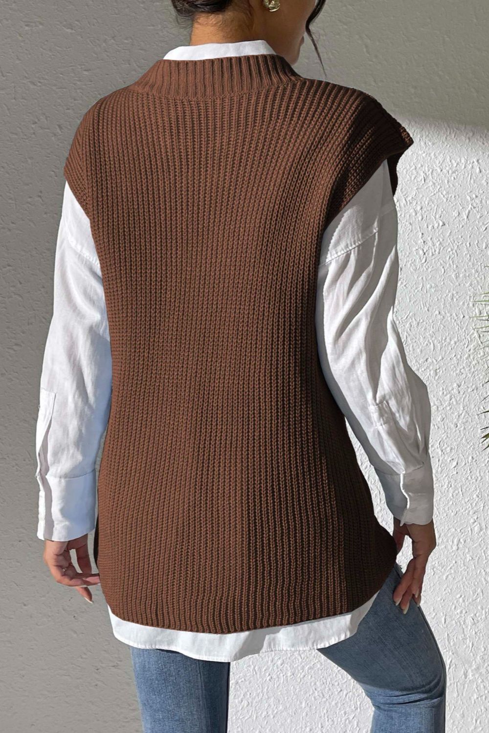 Chocolate textured knit V-neck sleeveless vest over a white button-down shirt.