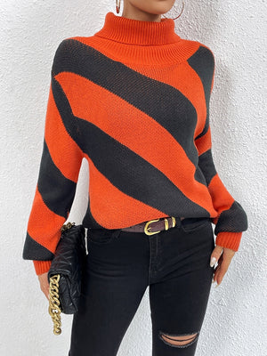 Orange-red and black diagonal stripe turtleneck knit sweater with long sleeves.