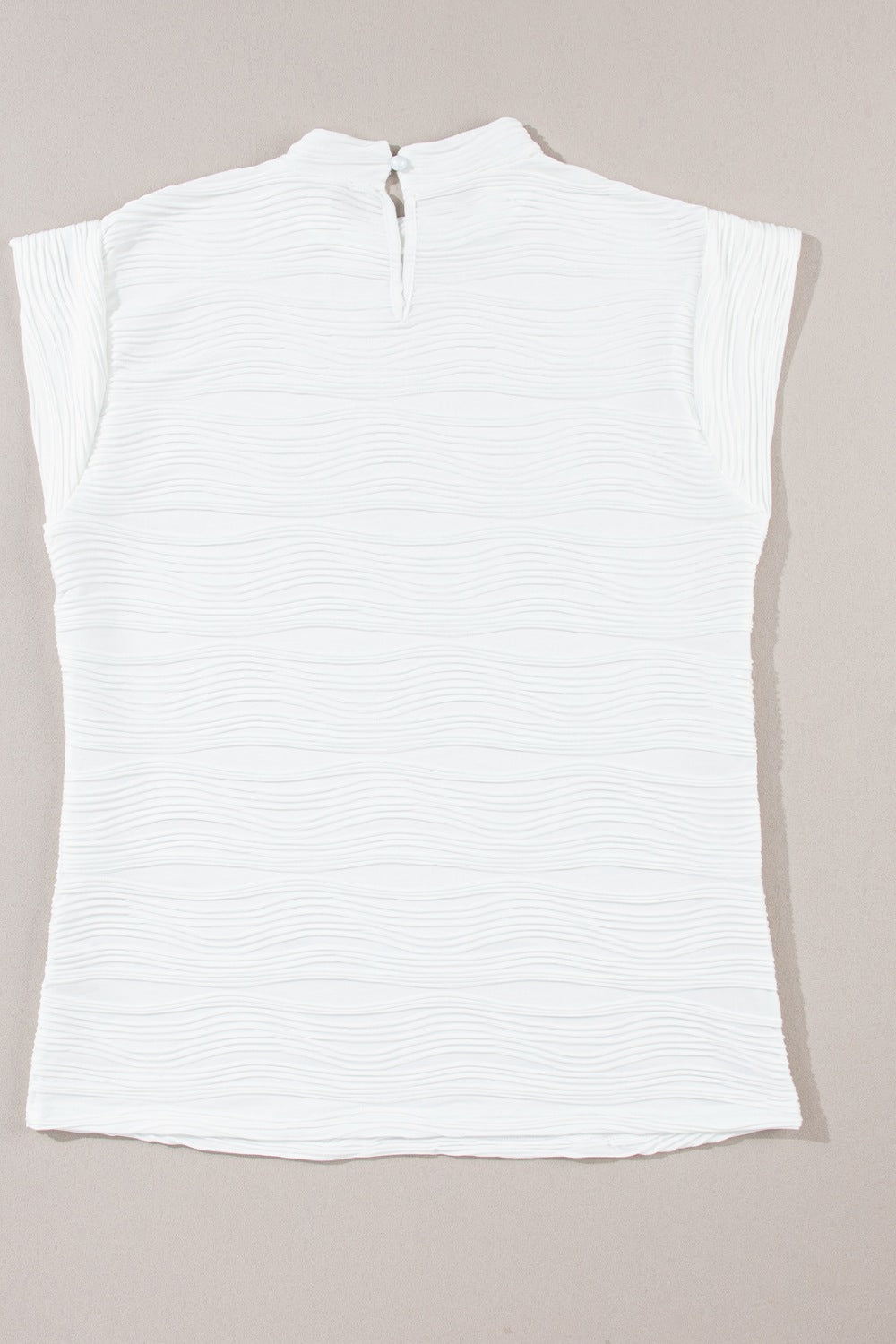 White textured wave cap-sleeve mock neck top with keyhole back closure