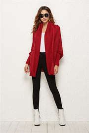 Textured cocoon knit cardigan in deep red with batwing sleeves and shawl collar.