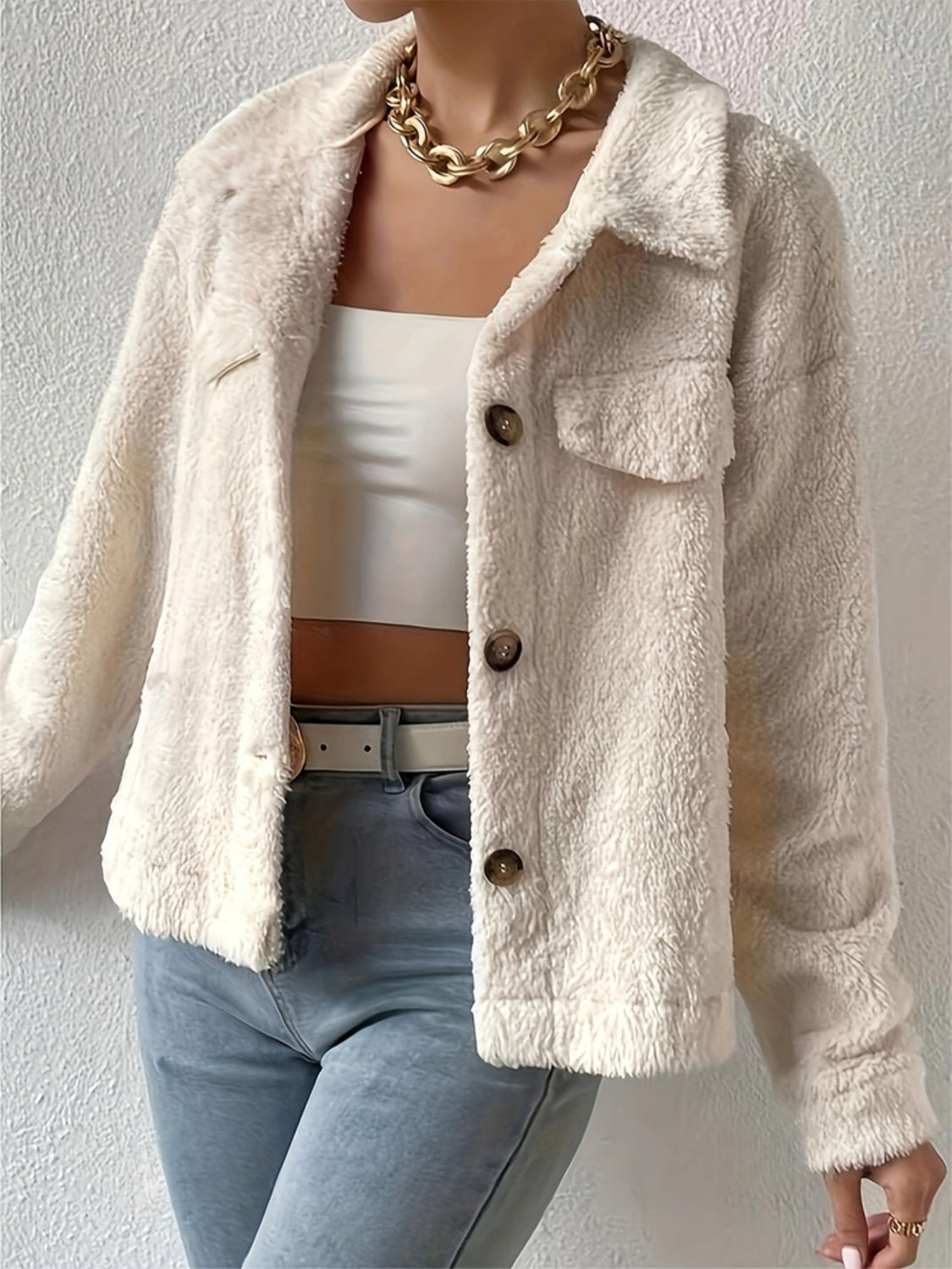Beige teddy bear textured shacket with button front and patch pockets.