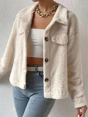 Beige teddy bear textured shacket with button front and patch pockets.