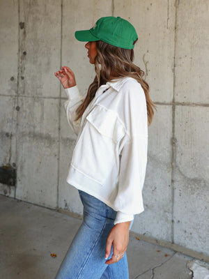 White textured boxy utility shirt jacket with button front and chest pockets.