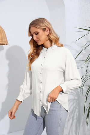 White mandarin collar blouse with button front and gathered sleeves.