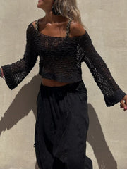 Black asymmetric crochet crop top with bell sleeves and a square neckline.
