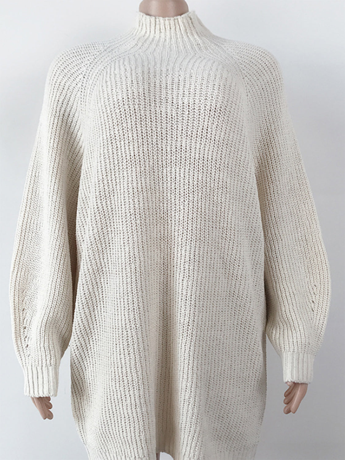 Cream ribbed knit cocoon turtleneck dress with long sleeves and a relaxed fit.