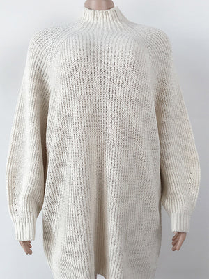 Cream ribbed knit cocoon turtleneck dress with long sleeves and a relaxed fit.