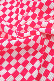 Pleated lounge set fabric in pink and white checkered plaid pattern.