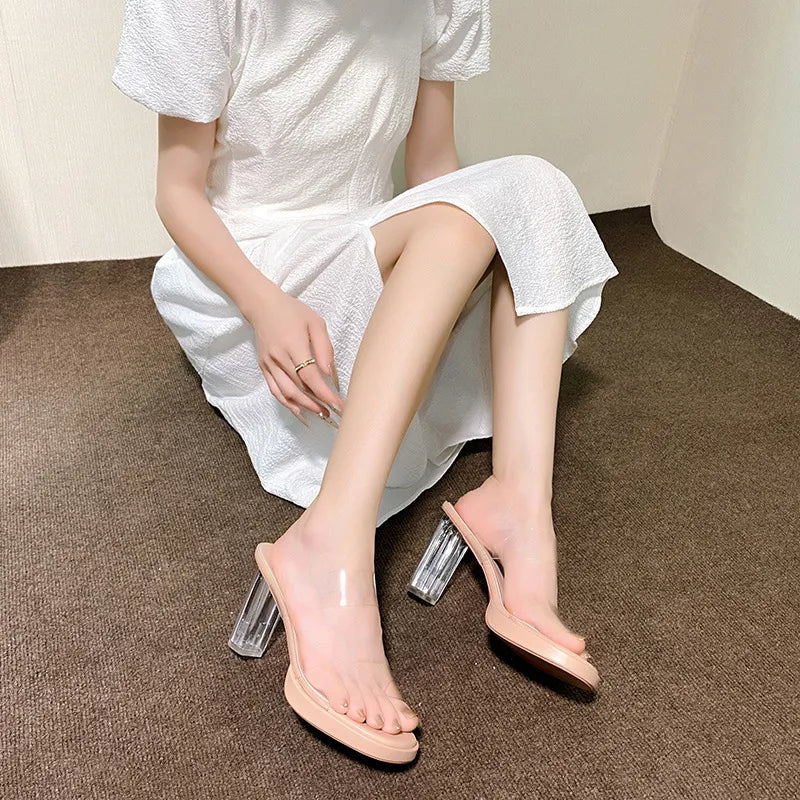 Apricot lucite heel platform slides with clear straps and block heels.