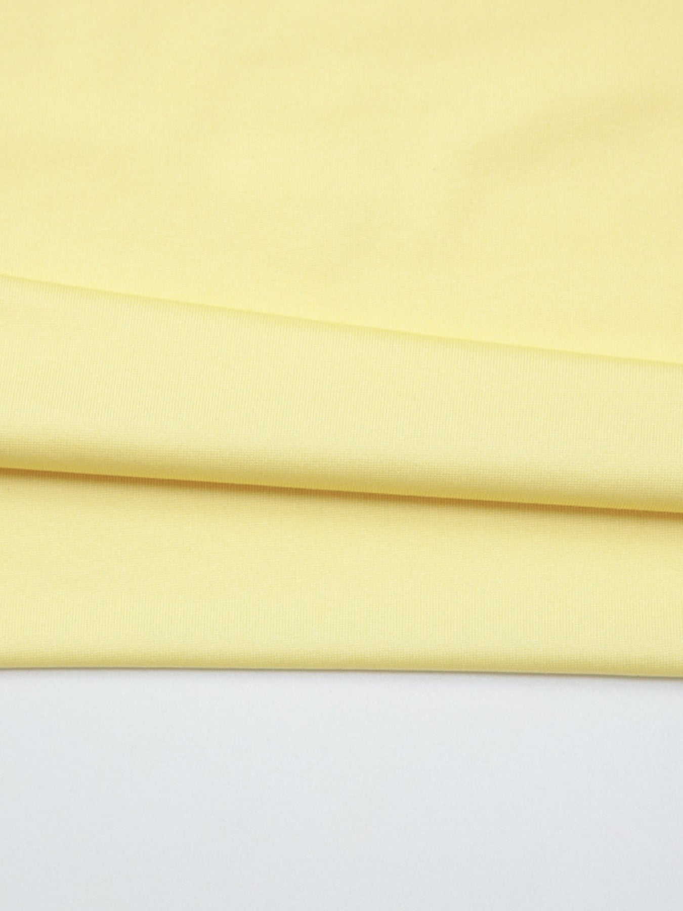 Off-shoulder ruched mini dress in pale yellow fabric with subtle texture.