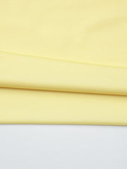 Off-shoulder ruched mini dress in pale yellow fabric with subtle texture.