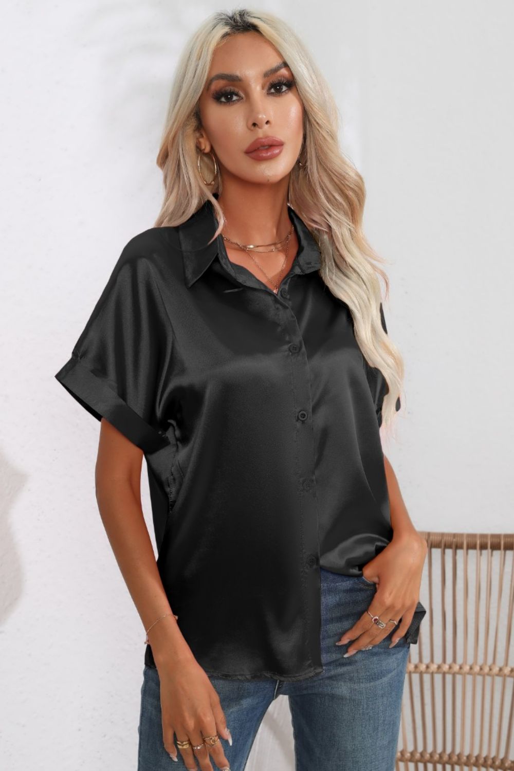 Black satin button-down blouse with cuffed short sleeves and a collared neckline.
