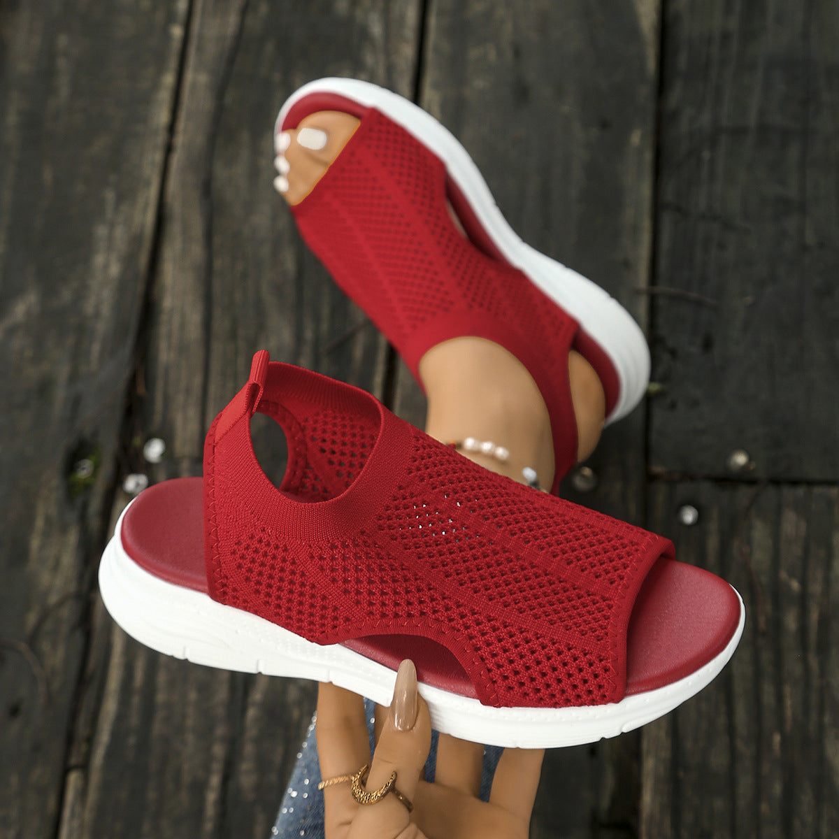 Red mesh open-toe sandals with a chunky white sole and comfortable fit.
