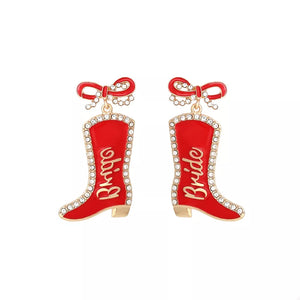 Red cowboy boot dangle earrings with "Bride" text and crystal trim.