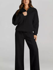 Black cotton zip-up jacket and drawstring pants set with front seam detail.