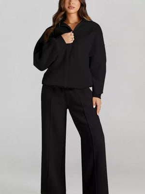 Black cotton zip-up jacket and drawstring pants set with front seam detail.