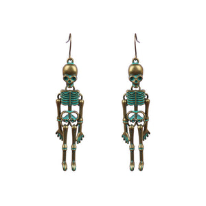Skeleton silhouette drop earrings in antique gold with teal accents.