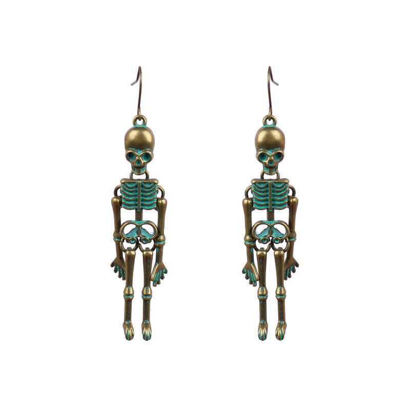 Skeleton silhouette drop earrings in antique gold with teal accents.