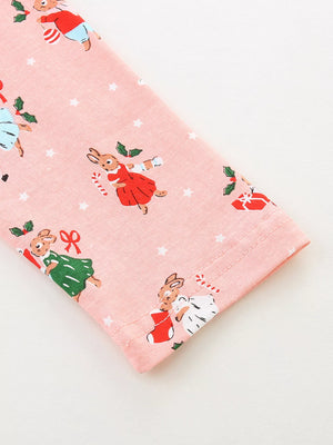 Pale blush cotton dress with a festive Christmas bunny print and white stars.