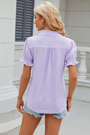 Lavender eyelet polo blouse with short ruffled sleeves and a collared neckline.