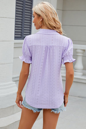 Lavender eyelet polo blouse with short ruffled sleeves and a collared neckline.