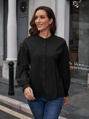 Black textured ruffle collar peplum blouse with button front and ruffled cuffs.