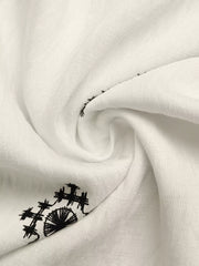 White midi dress with black geometric embroidery detail
