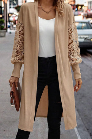 Tan ribbed knit duster cardigan with intricate lace sleeves and open front.