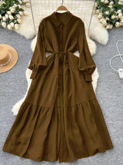 Textured tiered long sleeve button-down dress in Olive Brown with a belted waist.