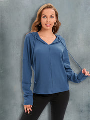 Dusty blue waffle knit hoodie with drawstring hood and relaxed fit.