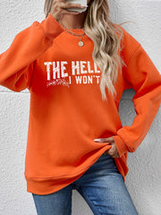 Graphic crewneck sweatshirt in pumpkin orange with white text and floral detail.