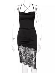 Black satin cowl neck dress with lace trim detail and crisscross straps.